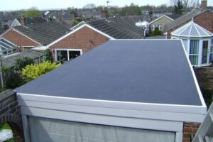 Flat roof on a residential extension with suburban homes in the background