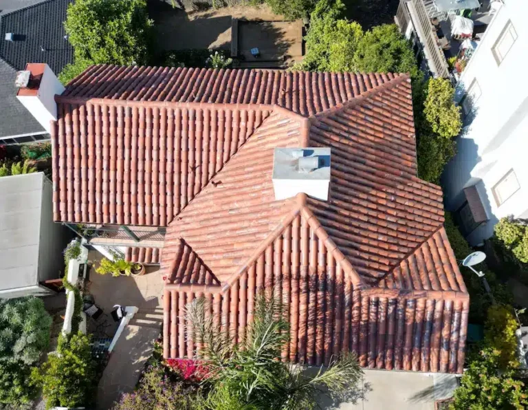 Newly installed red clay tile roof with clean ridge lines and vibrant finish