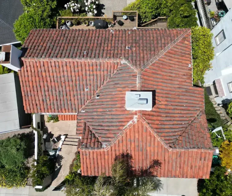 Aerial view of worn clay tile roof with faded and discolored sections