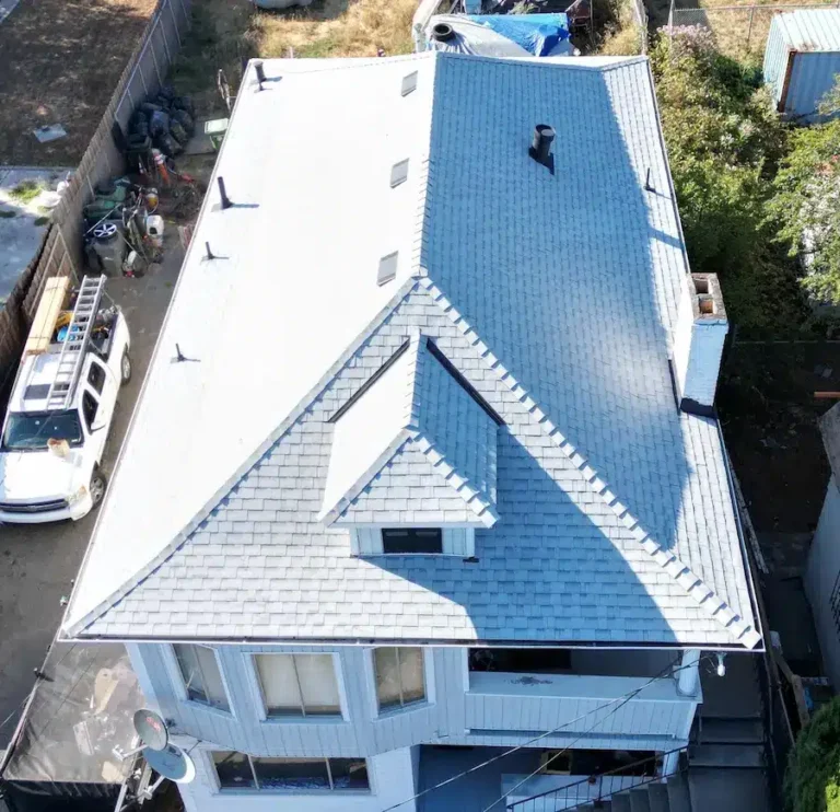 Cool Roofing Bright gray-blue architectural shingle roof after complete installation