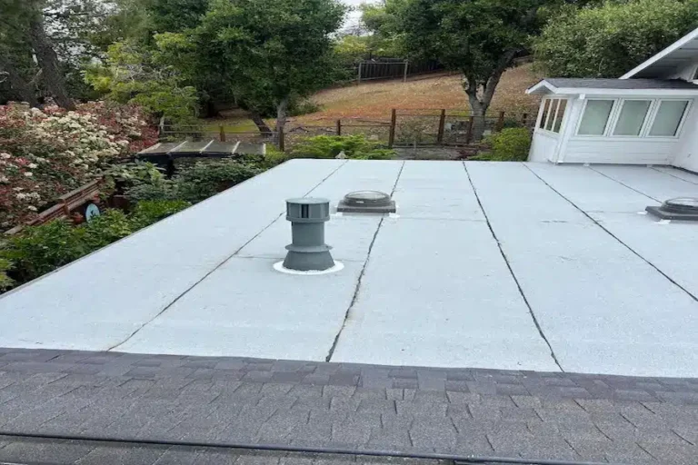 Flat roof after restoration with new gravel coating and sealed vents