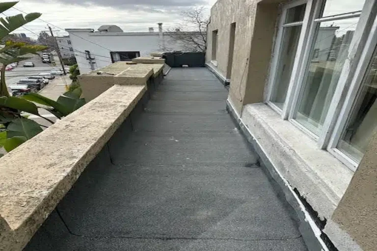 Flat roof walkway after resurfacing with new membrane by Lifetime Roofing & Renovation