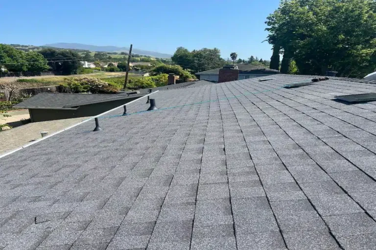 New gray asphalt shingle roof replacing old wood shake roofing on a residential home