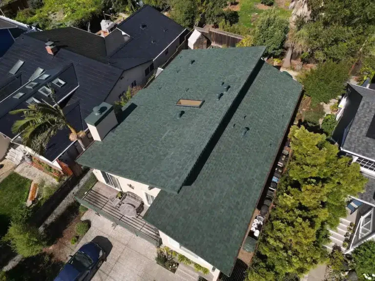 Freshly installed green architectural shingle roof on a residential home by Lifetime Roofing & Renovation