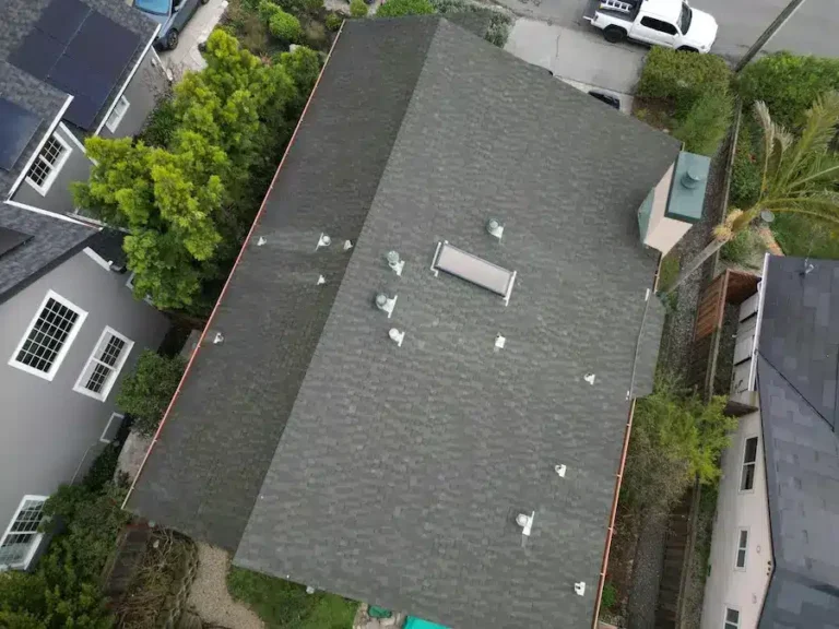 Overhead view of aging gray shingle roof before replacement on residential home