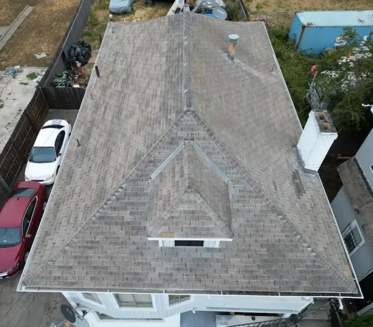 Old light brown shingle roof with discoloration and signs of aging