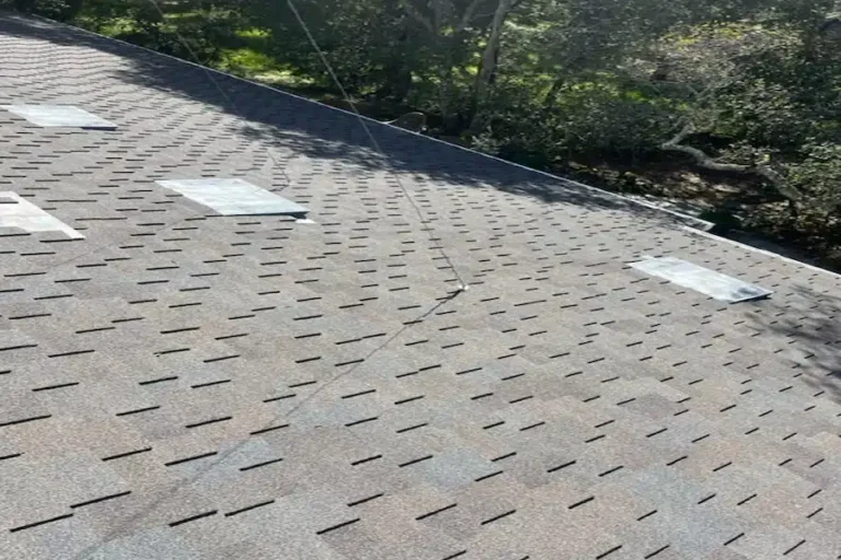Close-up of old roof before replacement with visible wear and temporary patches