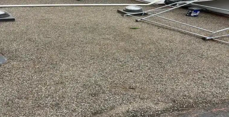 Flat roof before restoration with aging membrane and visible seams
