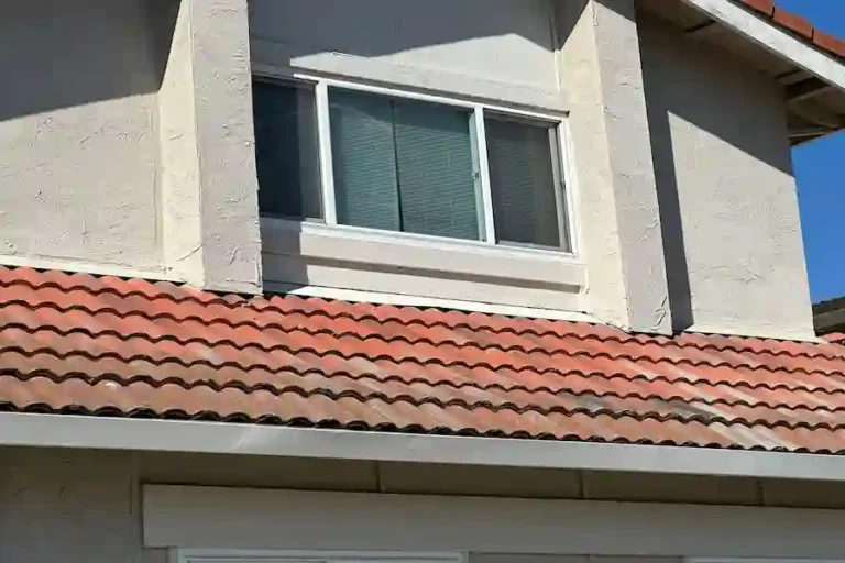 Newly installed fascia boards and replaced concrete tiles on a red tile roof in Milpitas, CA.