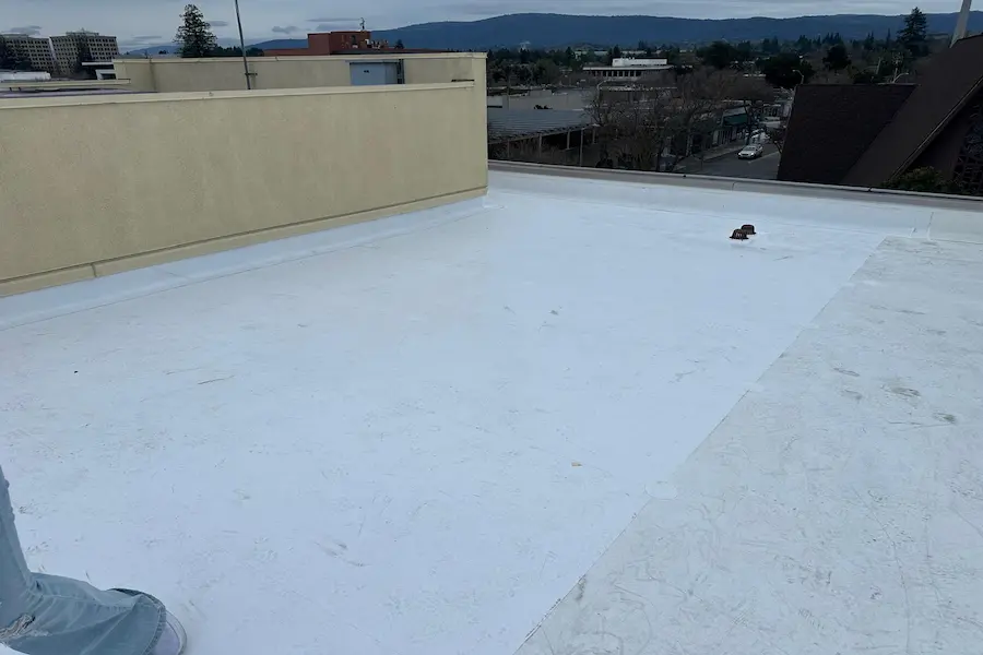 Finished white single-ply membrane on a commercial building roof overlooking downtown Palo Alto