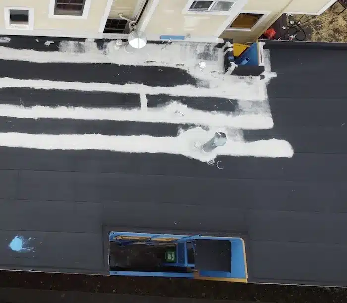 Patched seams and penetrations on the aging flat roof before the TPO overlay in San Francisco
