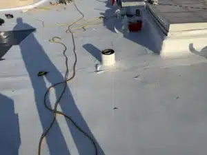 Freshly installed bright white TPO membrane covering the flat roof after a single-ply overlay at 2219 26th Avenue, San Francisco CA