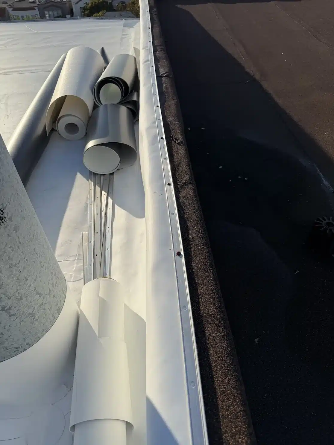 New TPO membrane and fresh edge metal installed along the parapet with TPO rolls staged at 2219 26th Avenue, San Francisco CA