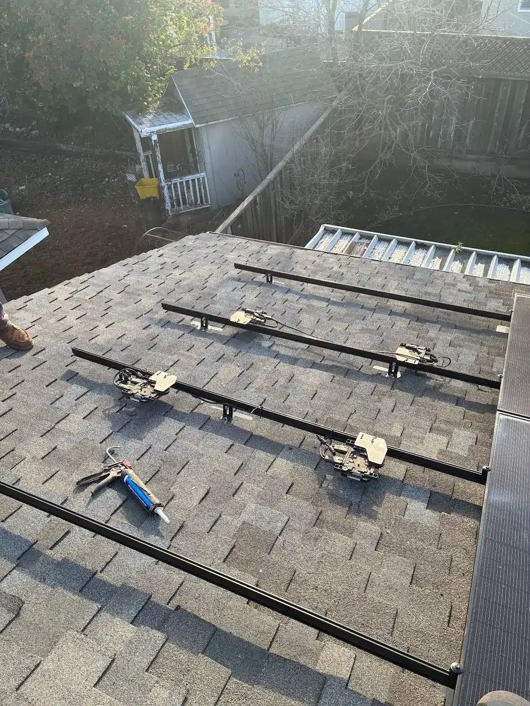 Solar mounting rails re-flashed and sealed on new asphalt shingles before panel reinstallation in San Jose