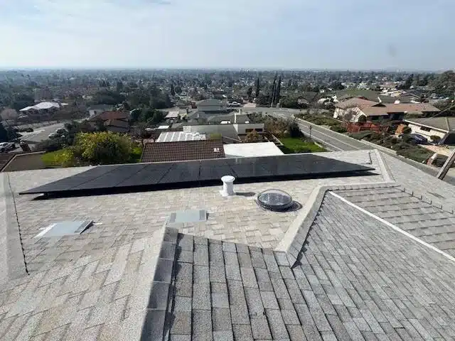 Aerial drone view of completed San Jose roof at 3480 Sweigert Road showing solar panel array reinstalled on new Owens Corning Oyster Shell architectural shingles