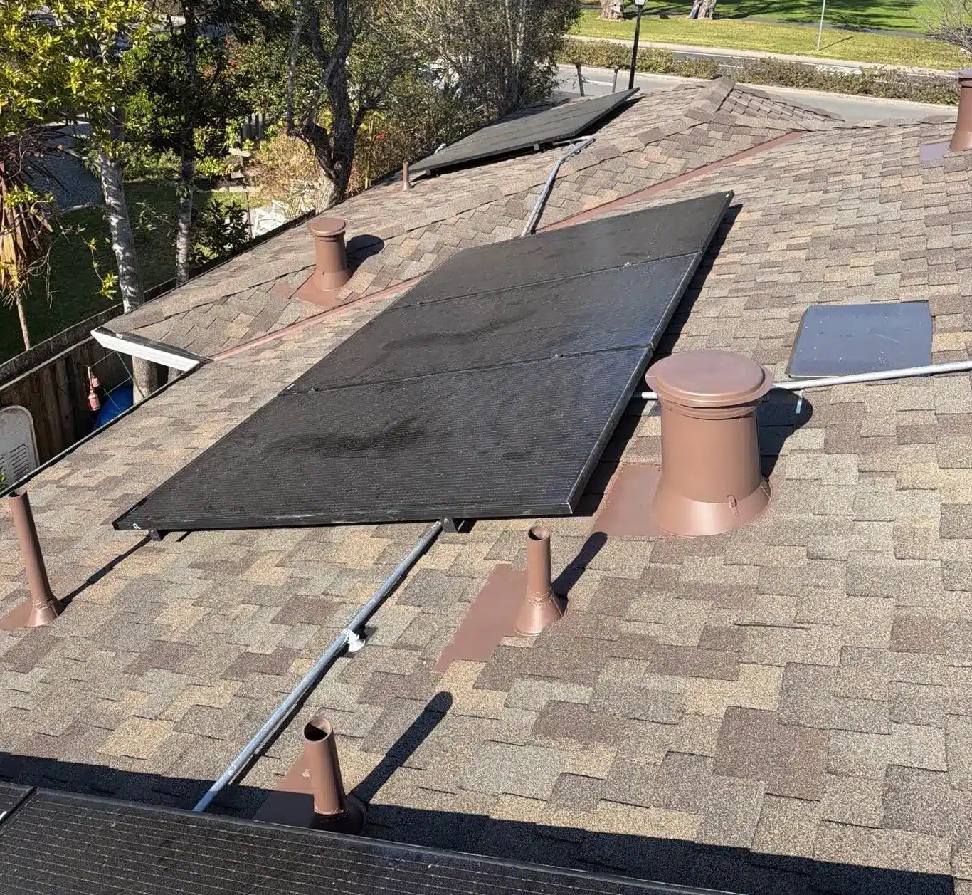 Finished Presidential-profile shingle roof with reset solar array and new gutters in Corte Madera, CA