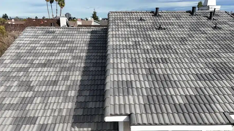 Two roof planes finished in blended charcoal-gray concrete tile after a Foster City re-roof
