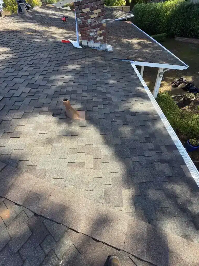 Completed shingle roof repair with color-matched Owens Corning Title 24 Cool Roof shingles and new pipe flashing in Los Altos, CA