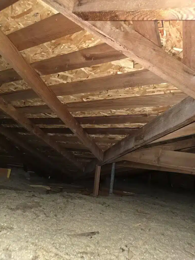 New roof decking installed over the rafters seen from inside the attic in Los Altos, CA