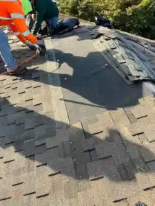Crew installing synthetic underlayment and weaving new shingles into the existing roof field in Los Altos, CA