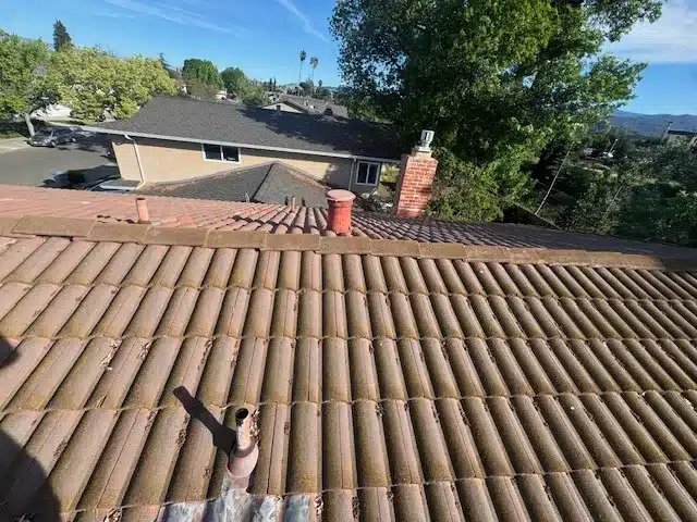 Before: aging concrete tile roof with moss on a South San Jose home prior to full replacement