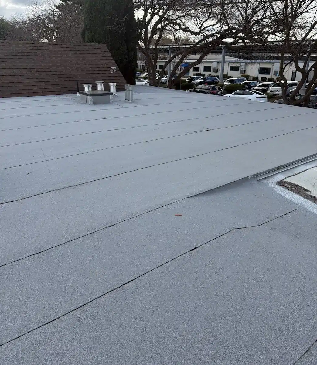 Finished light-colored granulated cap sheet flat roof after replacement in Sunnyvale, CA