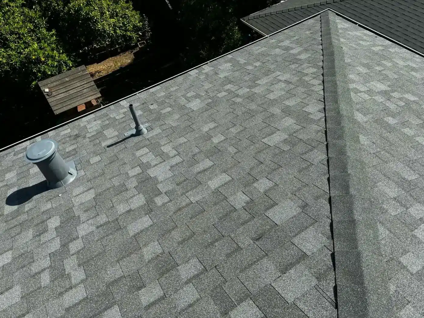 Finished gray architectural shingle roof with new painted vent stacks in Milpitas, CA