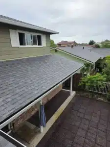 New gray architectural shingle roof and new white gutters after a full reroof in Milpitas, CA