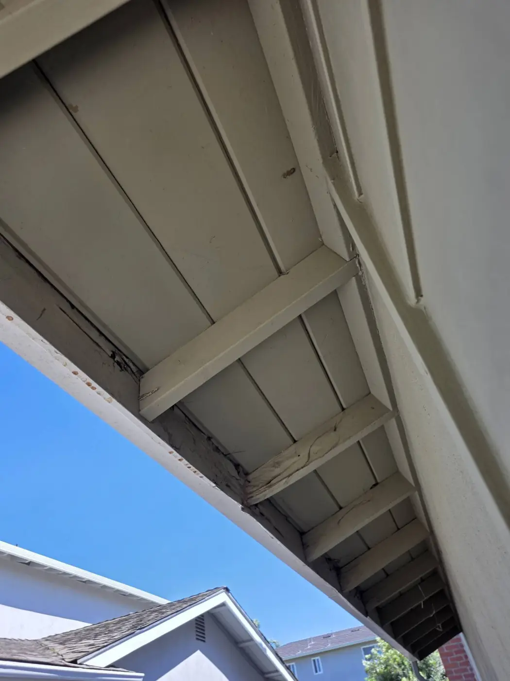 Rotted rafter tails and fascia board along the gutter line before reroofing in Milpitas, CA