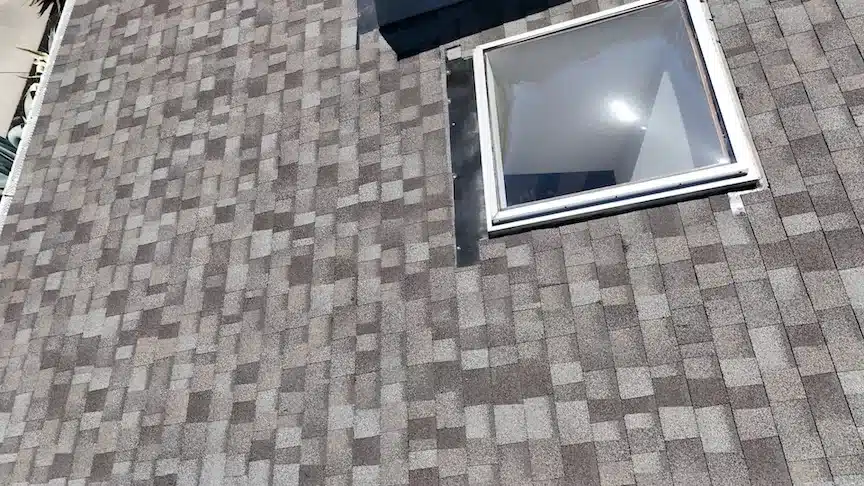 Close-up of a re-flashed skylight set into a new cool-roof shingle field in Pleasanton, CA