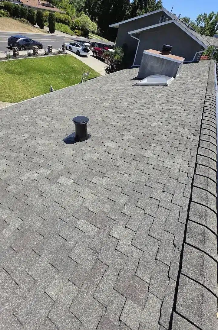 Worn, granule-loss asphalt shingles and an aging vent on the Pleasanton roof before replacement