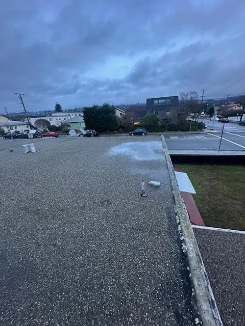 Aging flat gravel roof before replacement on Page Street in West Berkeley
