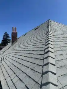 Finished Shasta White architectural shingle roof with hip ridge caps and brick chimney at 1117 Union Street, Alameda CA