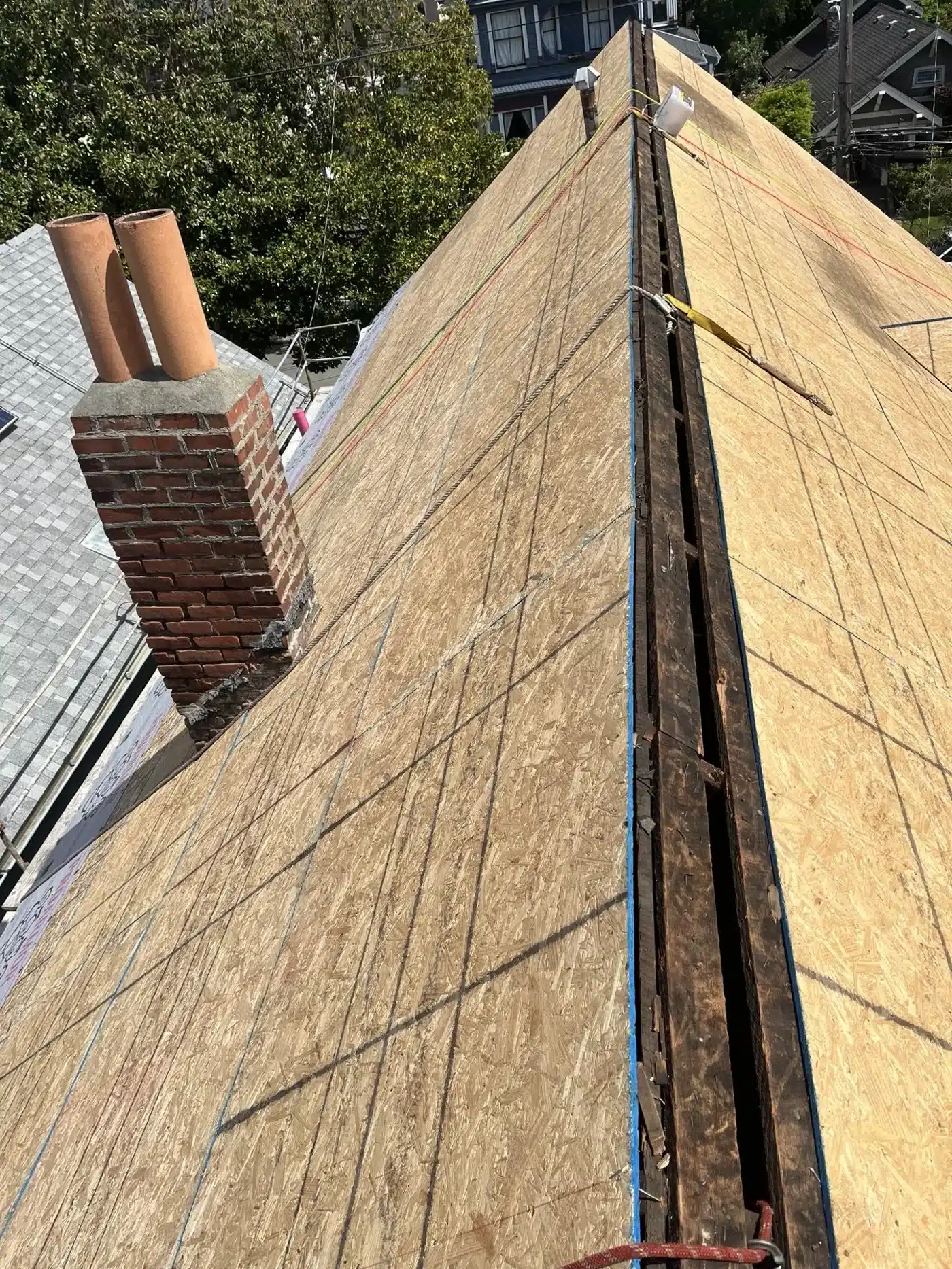 New plywood decking installed over the old skip sheathing, with the ridge open, at 1117 Union Street, Alameda CA