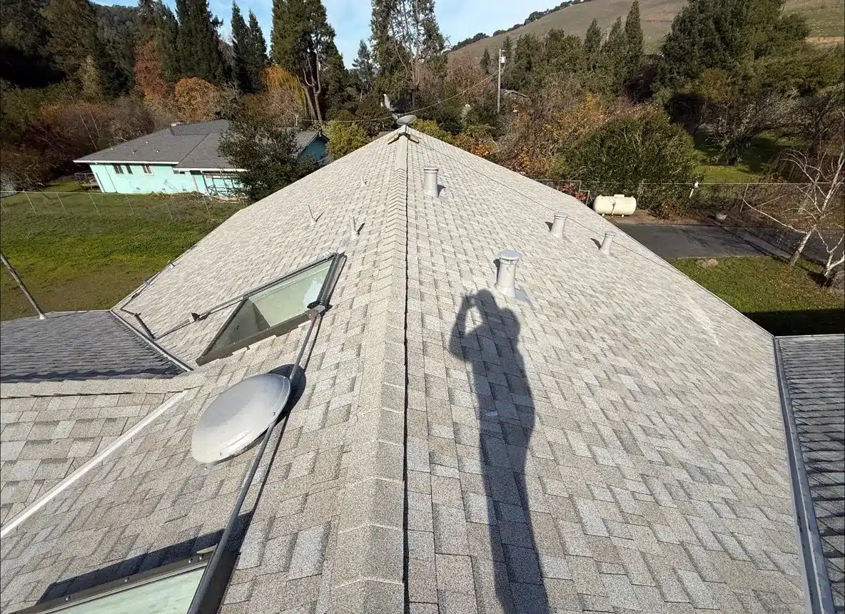 Aerial view down the ridge of the finished Castro Valley roof with a new skylight