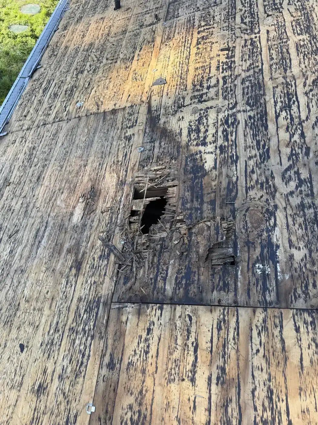 Rotted roof decking with a hole found during the Castro Valley roof inspection