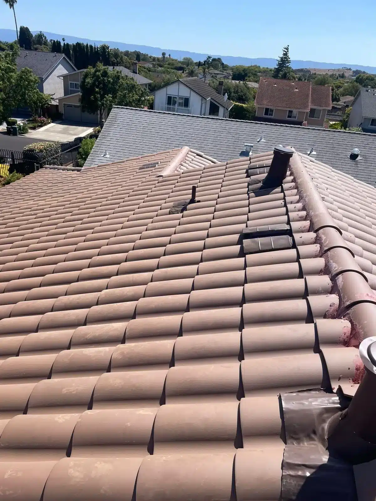 Finished brown concrete tile re-roof on a Bay Area home