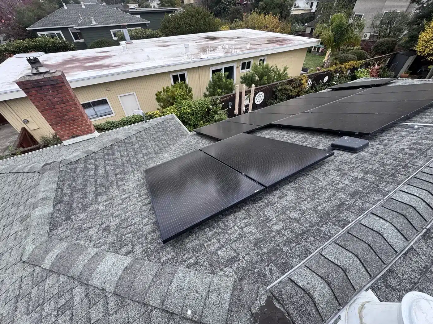 Solar panels mounted on an aging shingle roof before replacement in Corte Madera, CA