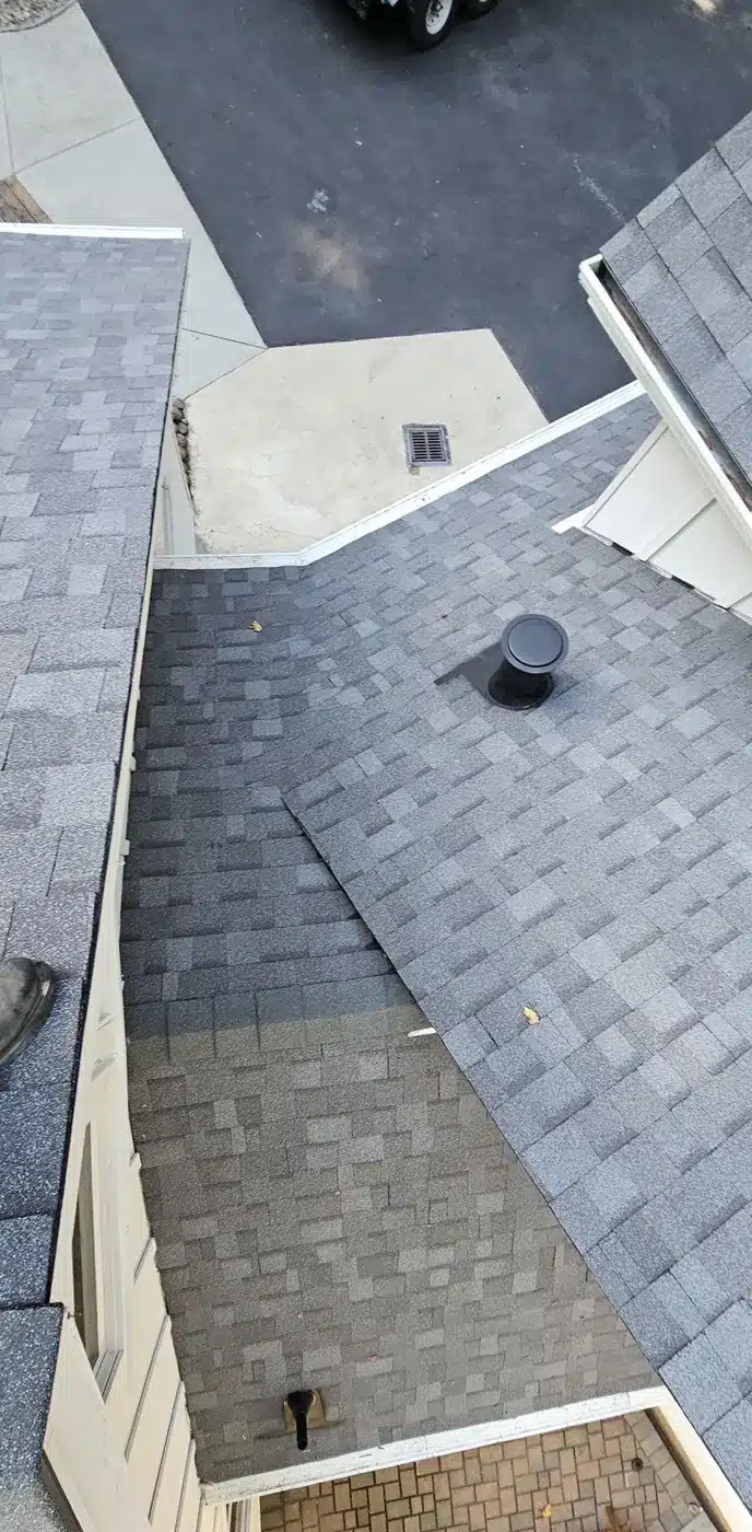 Aerial view of the finished light gray shingle roof and valleys on a Felton mountain home
