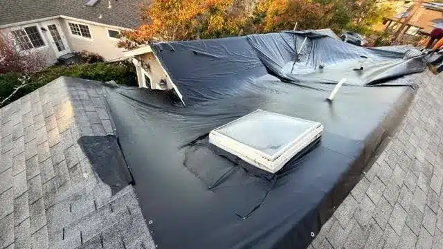 Emergency tarp over a leaking skylight section on a low-slope roof in Mill Valley, CA