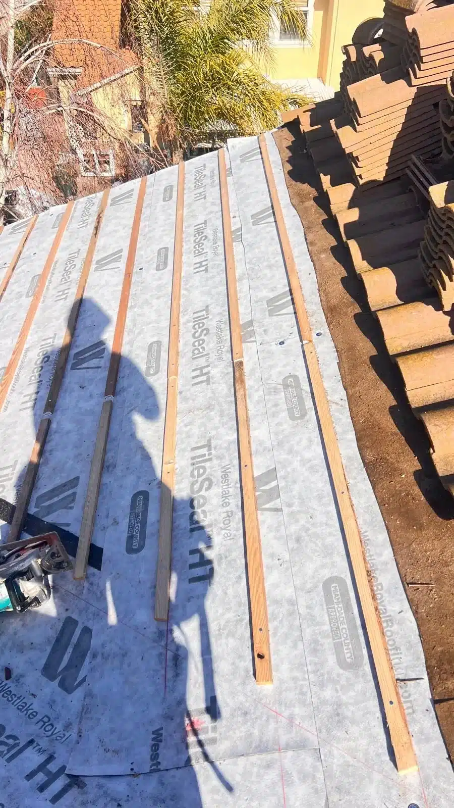 New underlayment and battens in place with the original concrete tile stacked on the roof ready to be relaid in Morgan Hill