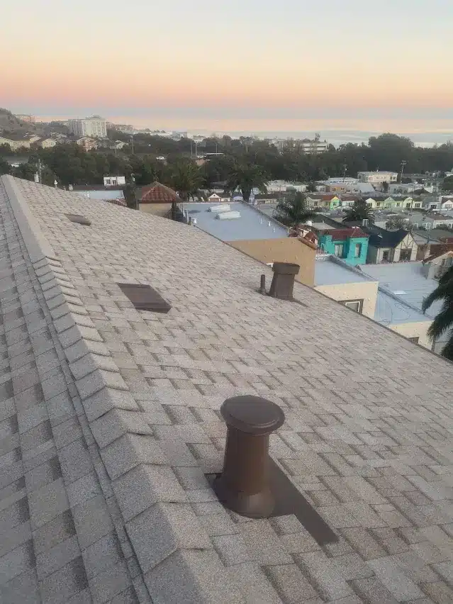 New shingle roof with San Francisco rowhouses in the background on Hester Avenue
