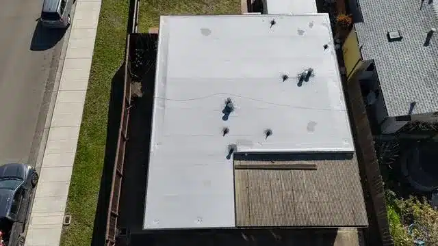 New white membrane flat roof after replacement on Page Street in West Berkeley
