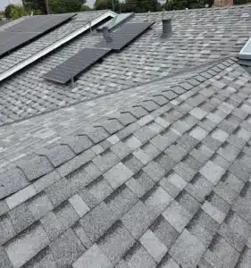 Finished grey architectural shingle roof on a San Jose home with the solar panels reinstalled after the reroof