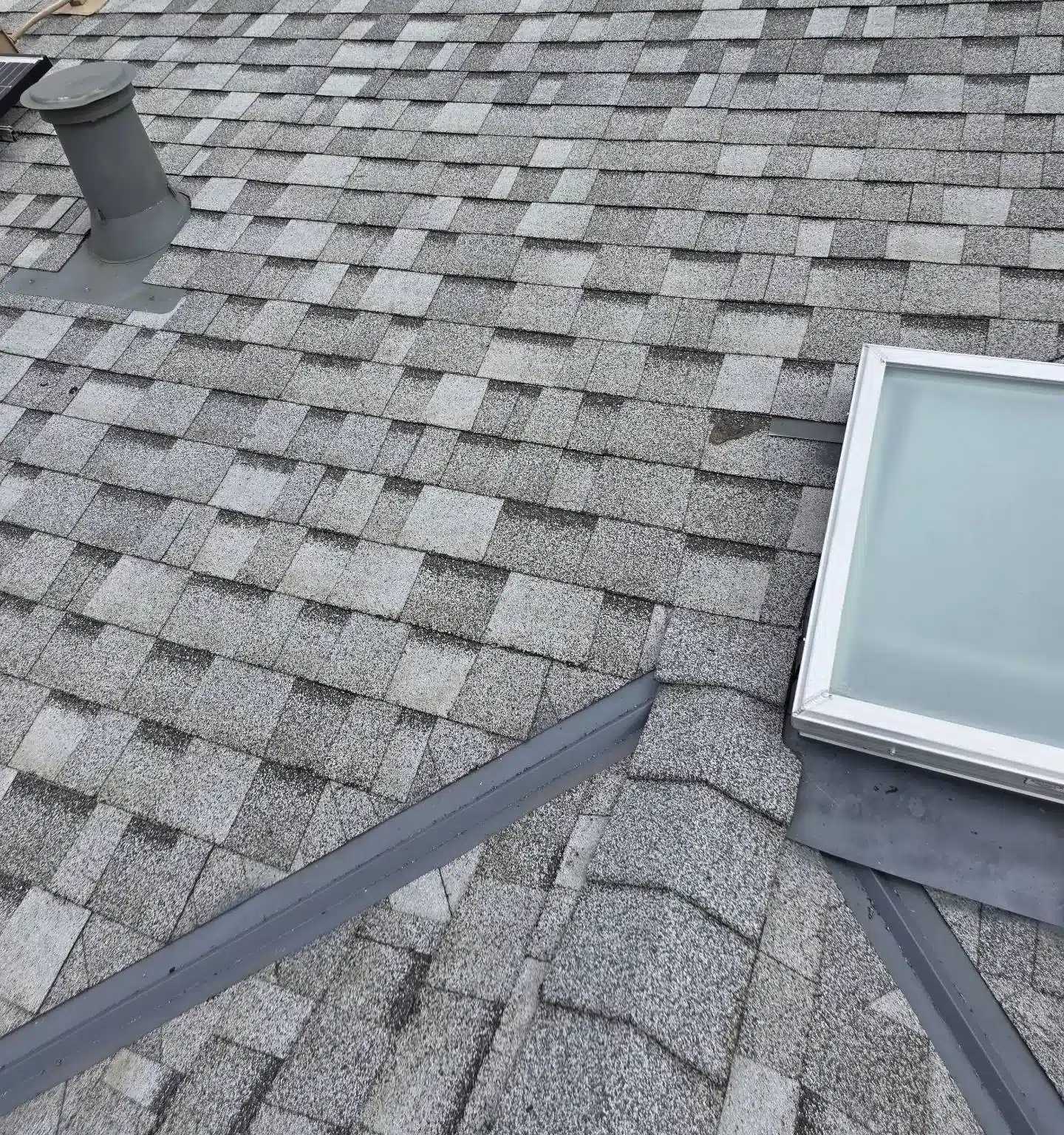 New skylight set into the finished architectural shingle roof on a San Jose home