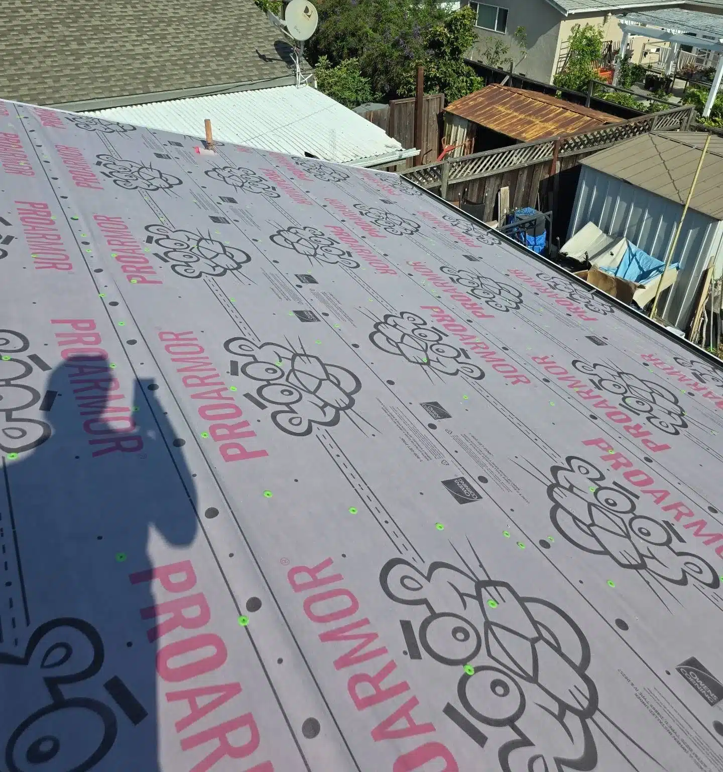 Synthetic underlayment rolled out over the new plywood decking on a San Jose reroof