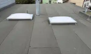 Completed low-slope roof with new cap sheet and rebuilt parapet in San Francisco