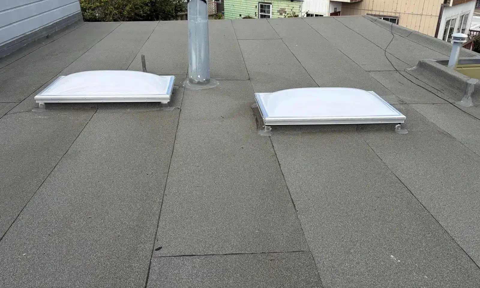Completed low-slope roof with new cap sheet and rebuilt parapet in San Francisco