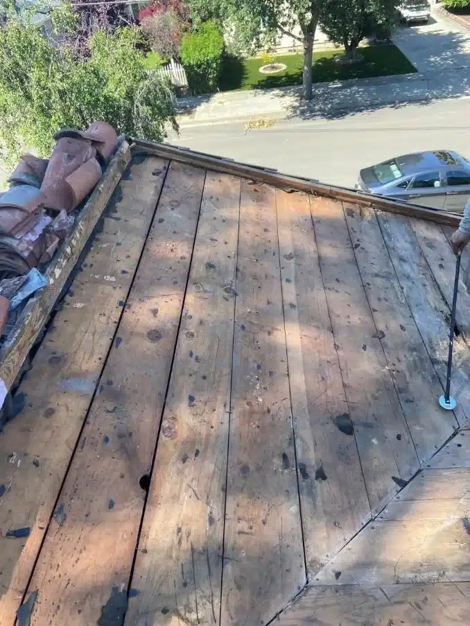 Original board sheathing exposed after the old underlayment was stripped at 1402 Clarita Avenue, San Jose CA