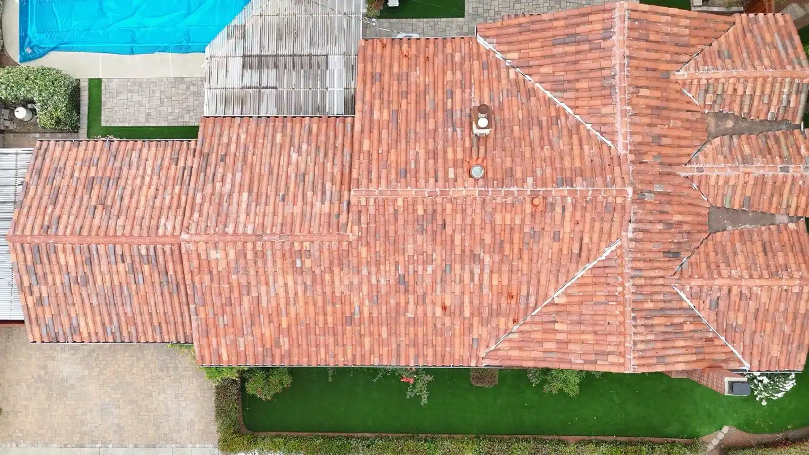 The original clay tiles relaid over new underlayment across the full roof at 1402 Clarita Avenue, San Jose CA
